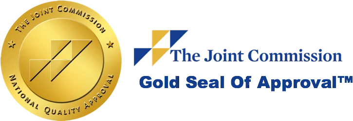 The Phoenix Recovery Center's (TPRC) Joint Commission Accredidation Seal in gold with four triangles and the text "The Joint Commission National Quality Approval" and beside it, "The Joint Comission Gold Seal of Approval TM