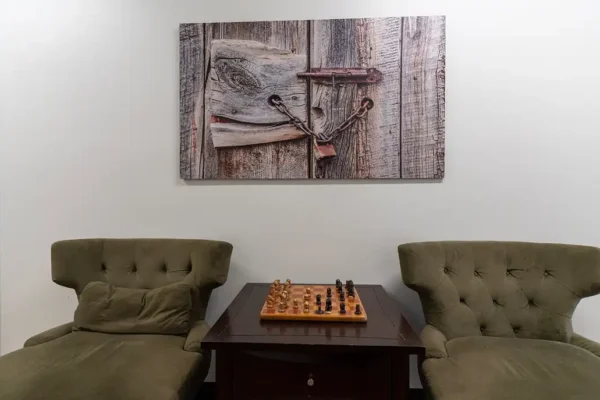 TPRC men’s residential common hallway with chairs and a chess board